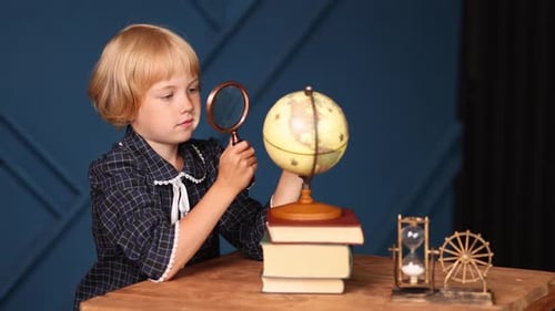 Young Child Exploring Globe with Magnifying Glass