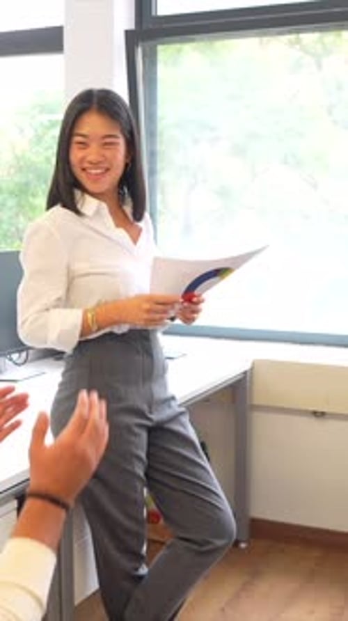 Young Woman Receiving Applause After Business Presentation