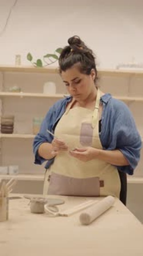 Ceramist Refining Clay Piece in Workshop