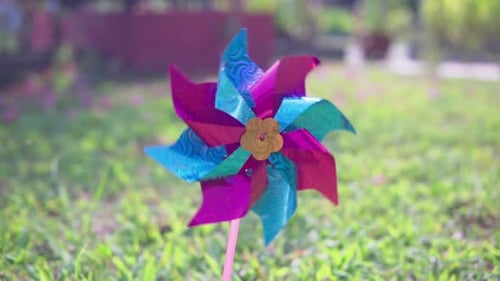 Toy pinwheel spinning in a garden