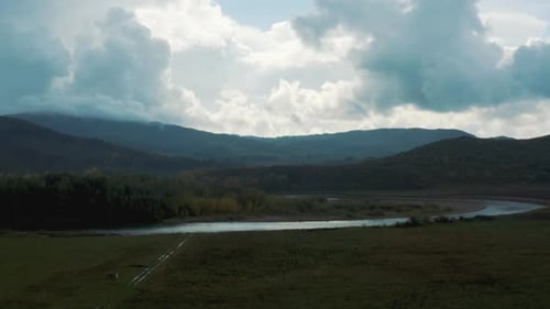 River Flowing Through Mountain Landscape