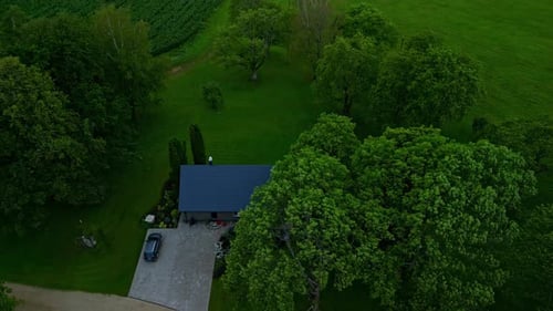 Home in the countryside at dusk - pullback tilt up aerial