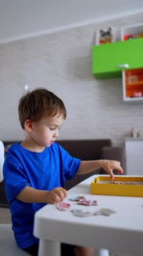 Cute Child Playing with Colorful Picture Tiles