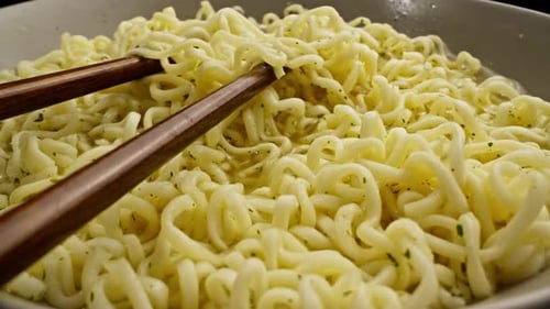 Close Up Noodles in Bowl with Chopsticks