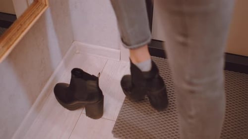 Close Up of Woman Putting on Shoes Adjusting Fit Before Leaving Home