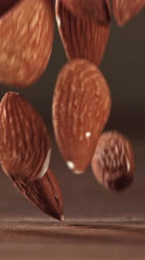Almonds Fall on a Wooden Table Filmed on a Highspeed Camera at 1000 Fps