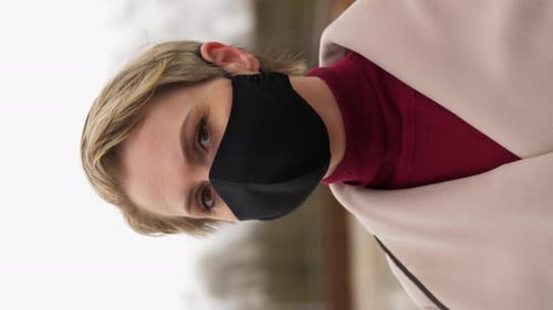 Woman Wearing Mask Looking at Camera in Winter