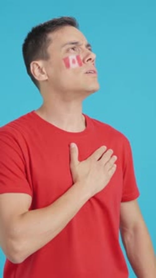 Man Listening to the Canada National Anthem with Solemnity