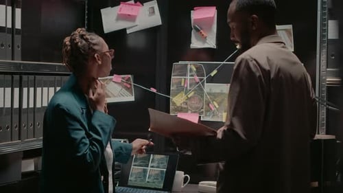 Detective Partners Analyzing Criminal Records in Office