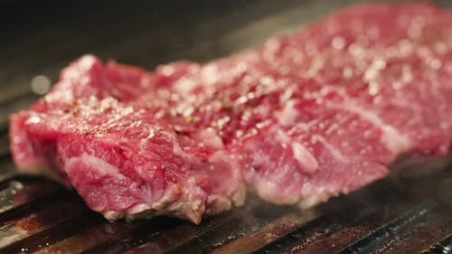 Cooking Beef Angus Steak in Restaurant Close Up Pieces of Hot Ribeye Steak Served on the Wooden
