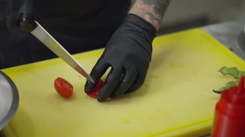 Person Cutting Tomato on Cutting Board