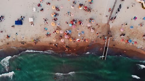 colorful umbrellas on the beach and drone view of the sea