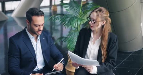 Professional Colleagues Analyzing Business Documents in an Office