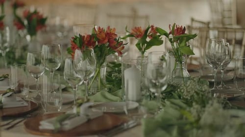 Wedding reception table setting with flowers and glasses