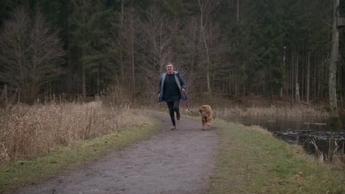 A Man Enjoying An Afternoon Run With His Chow Chow Dog