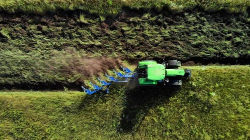 Aerial View of Tractor That Plows Land Preparing Soil for Planting and Cultivating Vegetables or Rye