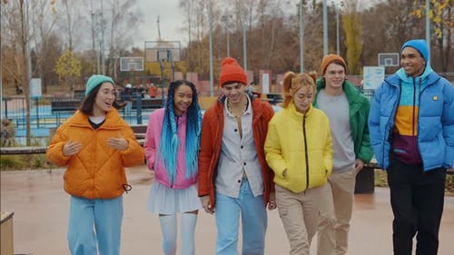 Group of Friends Walking and Smiling in Park