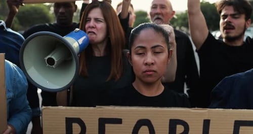 Protesters Marching with Signs and Megaphone