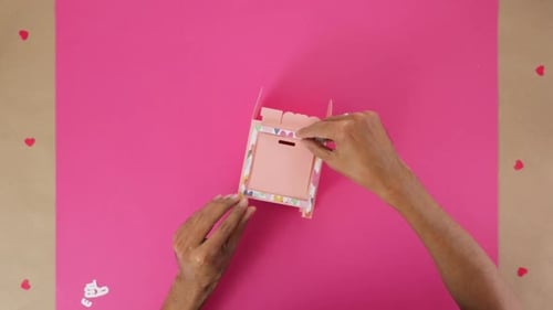 Hands Assembling a Paper Craft Box Top View