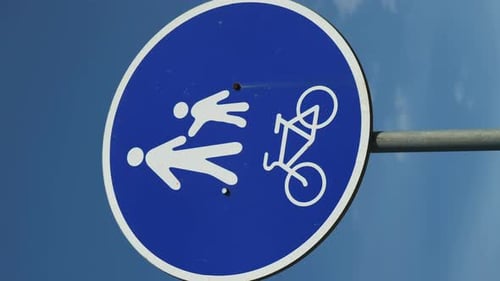Sign Zone for bicycles and pedestrians against blue sky. Vertical video