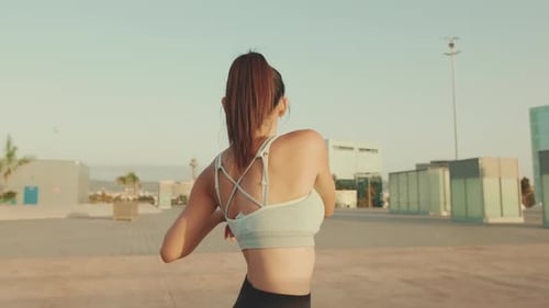 Woman Stretching Arms Outdoors in Urban Setting