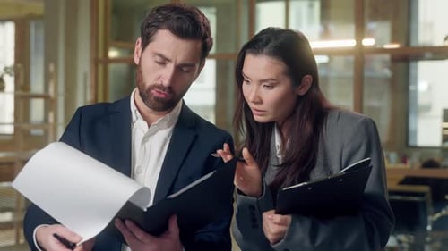 Multiethnic Korean Businesswoman Caucasian Businessman Review Documents Serious Office Business