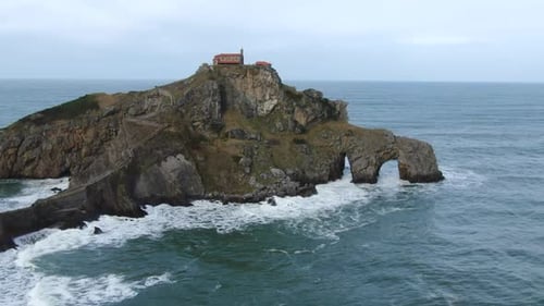 Aerial zoom in shot Gaztelugache is an islet in the Vizcaya town of Bermeo, Pais Vasco, Spain.