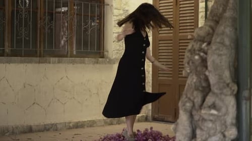 Woman Dancing on Terrace with Flowers