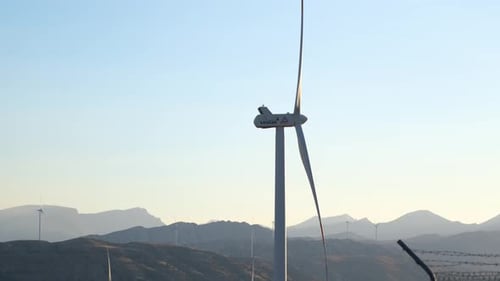 Wind Turbines Spinning in a Mountainous Landscape