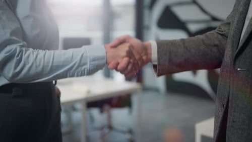 Male and Female Caucasian Hands Shaking Investment Concept in Sunny Office Unknown Successful