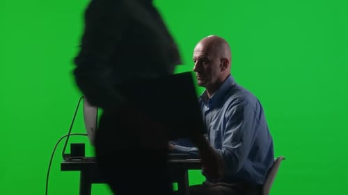 Businessman Working on Computer in Studio with Green Chroma Key Wall