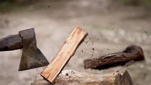 Chopping Wood with Ax on Log and Spreads Shavings, Close Up