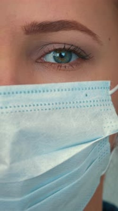 Woman Wearing a Surgical Mask in Close Up