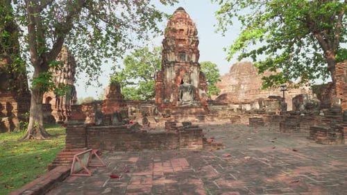 Buddha statue among ruins of the Wat Mahathat in Ayutthaya