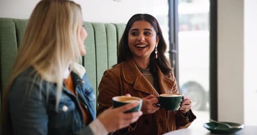 Women, friends and laugh with coffee in cafe for bonding together, happy reunion and support