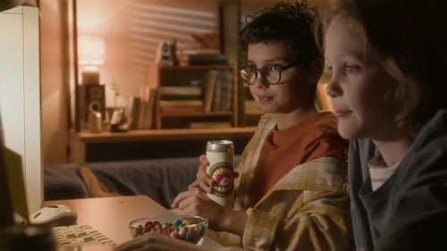 Children Gaming at Computer in Bedroom at Night