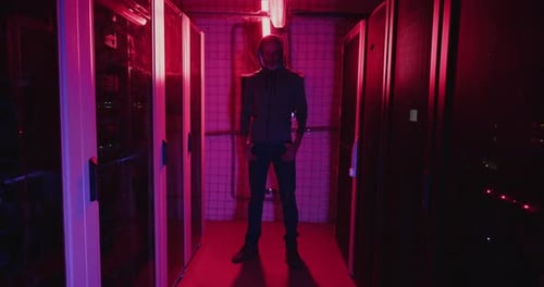 Man Standing in a Dark Server Room