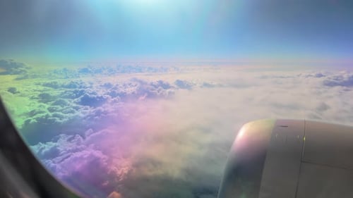 Aerial View of Clouds Through Airplane Window