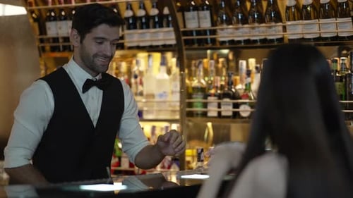 Bartender and customer at night club.