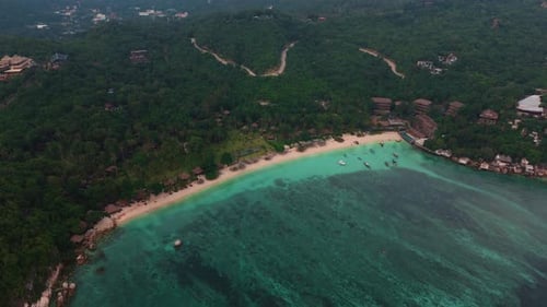 Tropical island, white sand beach and lush vegetation with clear turquoise water. Koh Tao Thailand