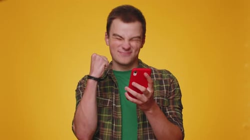 Man Excited By Success on Smartphone