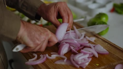 Slicing Red Onion on Cutting Board in Kitchen