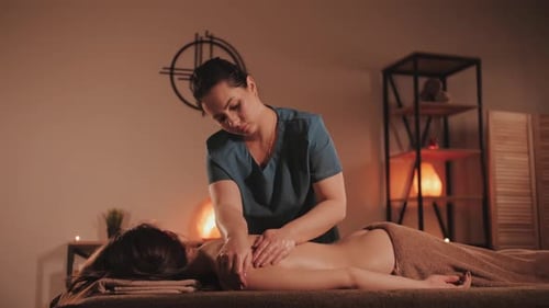 Master makes a professional massage, spa salon. Relaxing and healthing procedure.