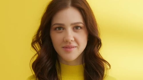 Young Woman Posing in Front of Yellow Background