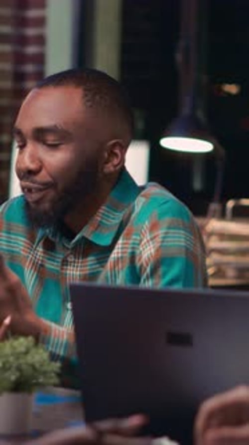 Young Adult Man Talking During a Meeting