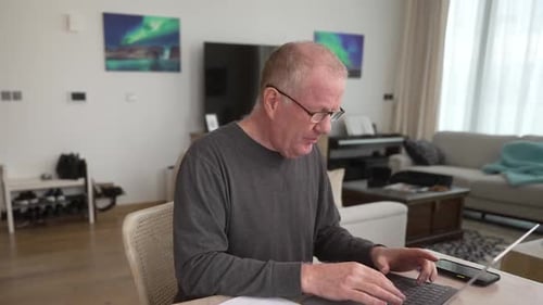 Adult Man Working on Laptop at Home