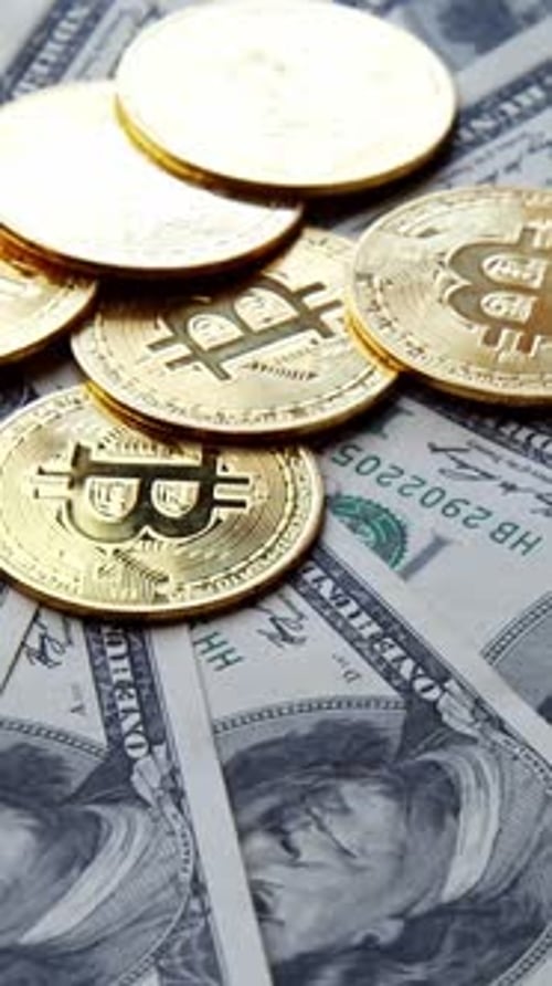 Close up of Bitcoin Coins on US Currency
