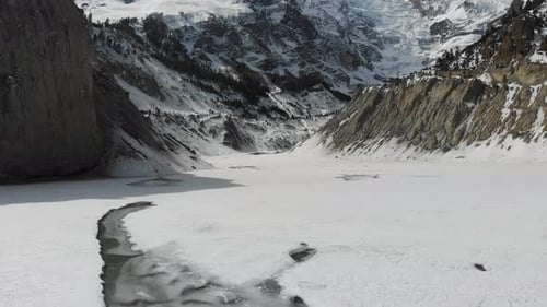 Drone zooming out of Gangapurna Glacial lake below Annapurna in Manang, Nepal