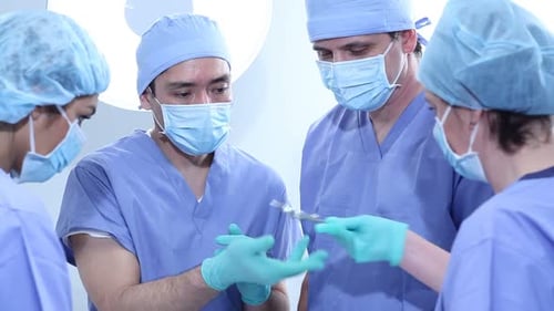 Surgeons Preparing Surgical Tools in Hospital Operating Room