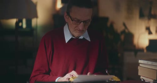 Man Typing on Vintage Typewriter at Night